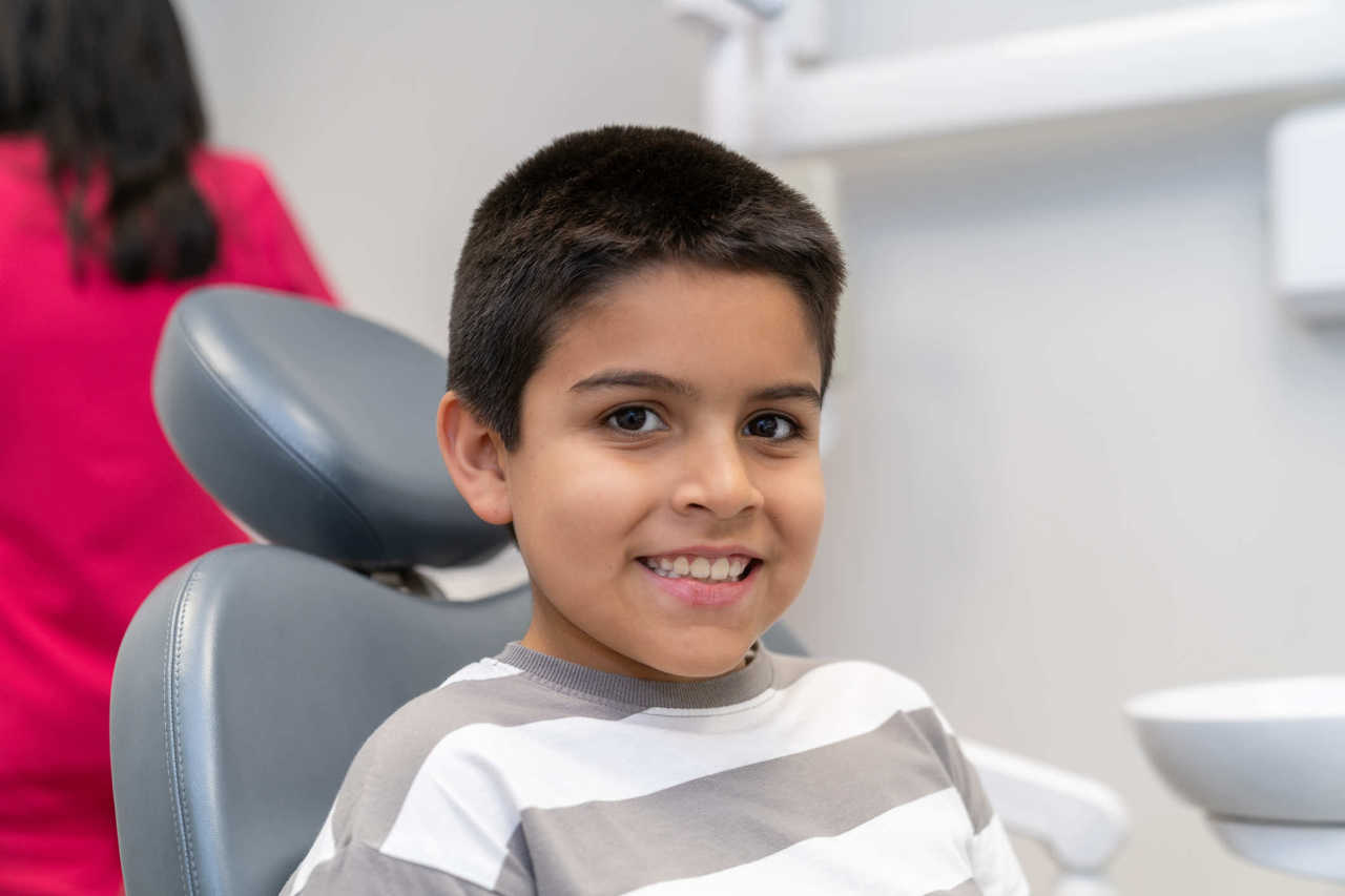 Happy child in 'big-kid chair' or friendly office atmosphere